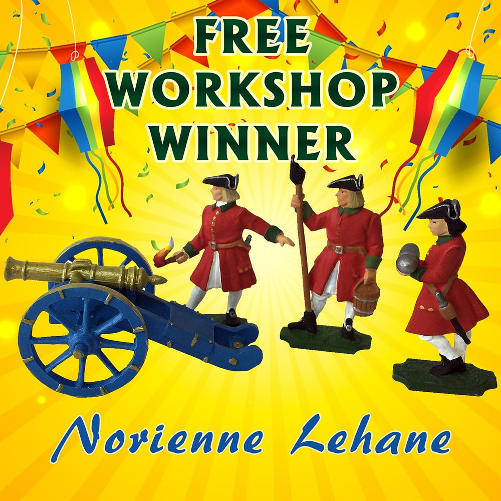 A graphic announcing "Free Workshop Winner." It features three toy soldiers in red uniforms and a blue cannon. Colorful banners and confetti decorate the background. The name "Norienne Lehane" is written at the bottom.