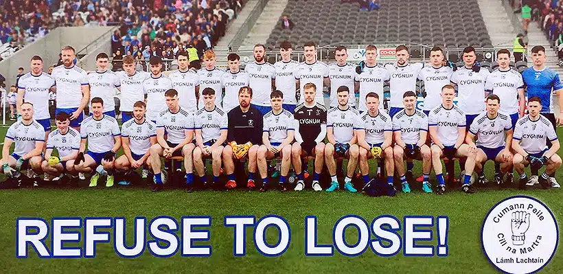 A Gaelic football team poses for a group photo in a stadium. The players are in two rows, wearing white uniforms. Beneath them, bold text reads "REFUSE TO LOSE!" In the bottom right corner, there's a circular logo with Gaelic text and imagery.